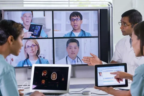 Panel of researchers onscreen talking with two researchers.